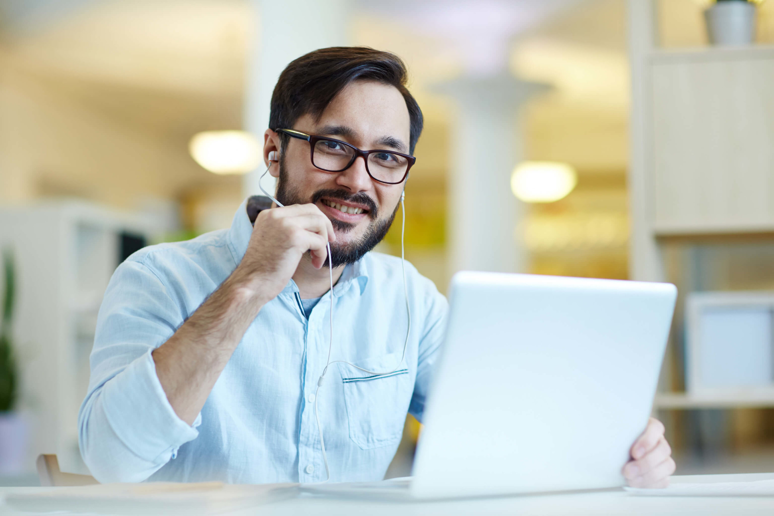 Male with career at Daon on laptop