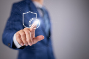 A man in a blue business suit points to a check mark on a clear glass pane